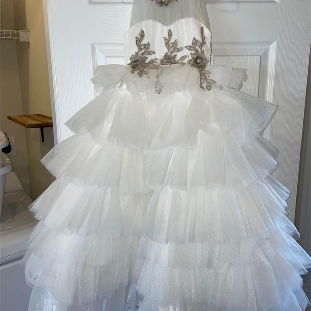 Like new. Very full tulle gown floor length 2T ivory in color
